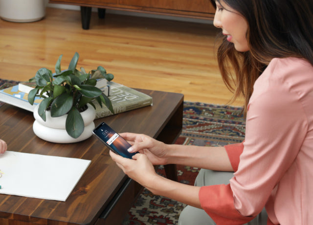 Woman using August app on Smartphone