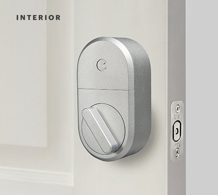 A silver August lock on an open door