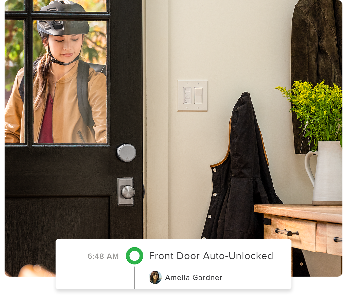 A woman entering her home with the door auto unlock when it receives her wifi signal