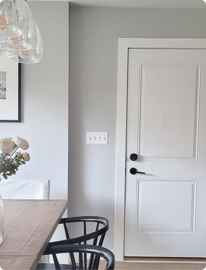 Dining room table and front door seen with an August smart lock