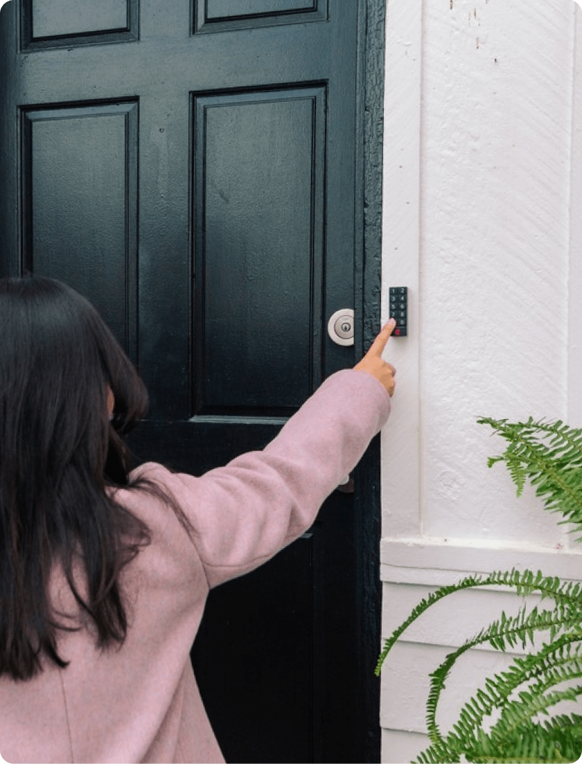 A little girl accessing a door keypad