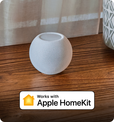 August home pod on a wooden table in the home. Works with apple home kit is in the description