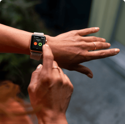  A woman with rings on uses her smart watch to lock her front door remotely