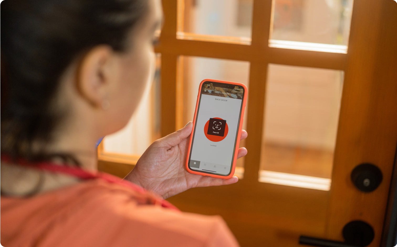 Woman using her smartphone to control her keyless entry smart lock
