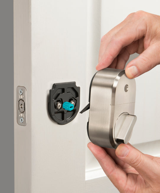 A silver wifi smart lock being installed