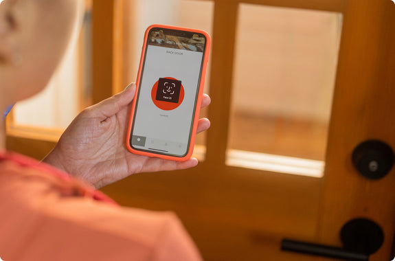 A man accessing his August app with face id on his smartphone