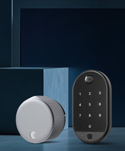 Two smart door locks, one silver and one black with digital keypad, on a dark blue background.