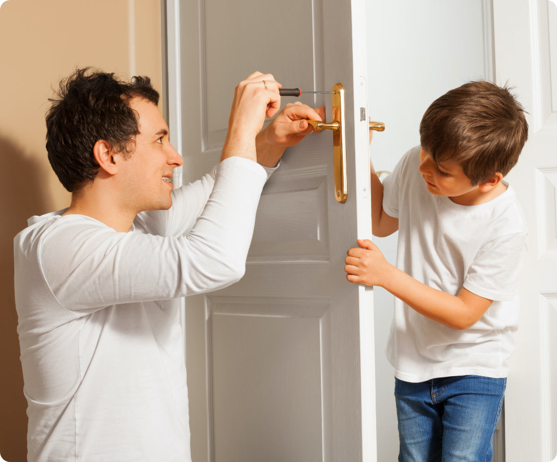 A man and his son installing a door handle