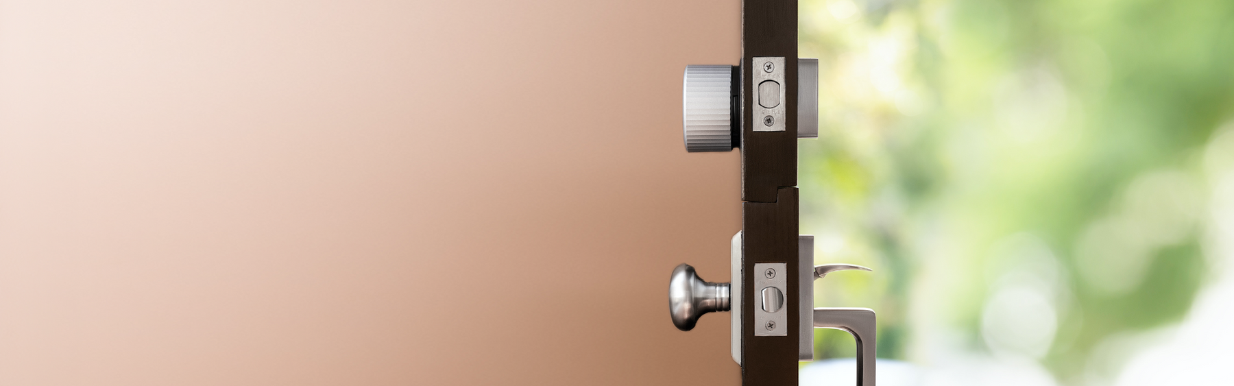 A side view of a silver August wifi lock installed on a door